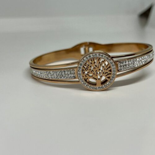 This exquisite rose gold bracelet features a stunning tree of life design, elegantly adorned with shimmering diamonds. The intricate craftsmanship highlights the symbolic connection to nature and life, making it a perfect accessory for any occasion. Its luxurious gold finish and sparkling diamonds create a timeless piece that embodies both beauty and meaning